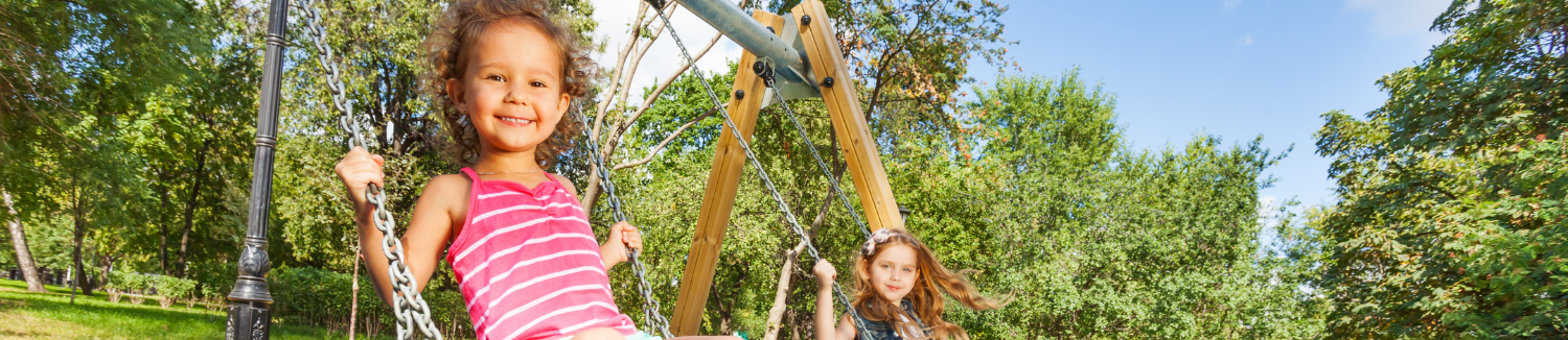 Young girls swinging outside