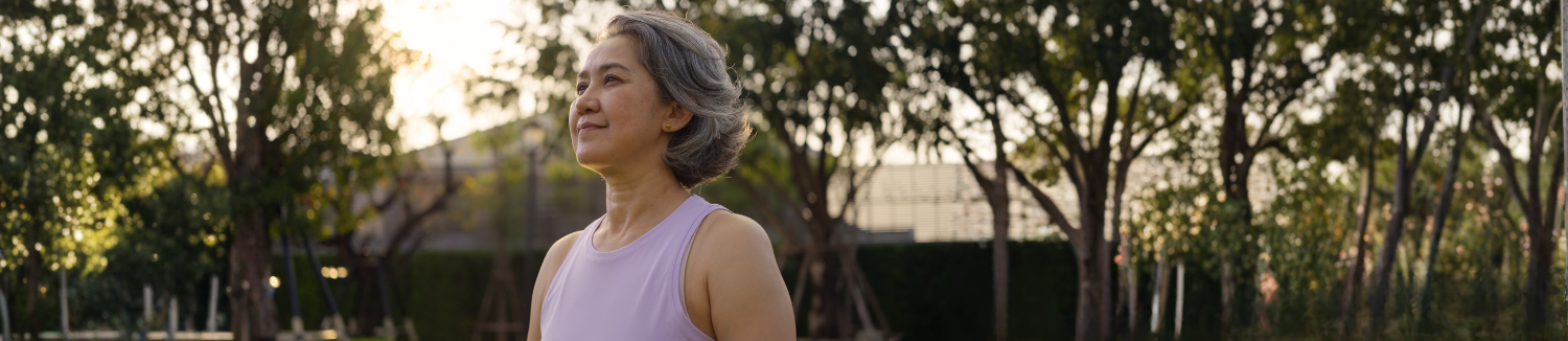Person standing outside in workout clothes with hopeful expression