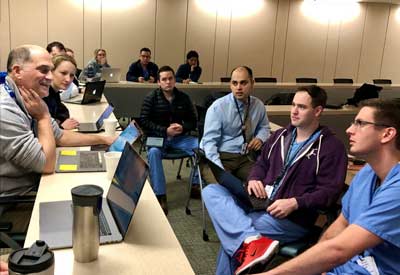 Hand fellows and attending physicians in conference