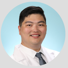 Photo of Dr. Alex Gu in white lab coat